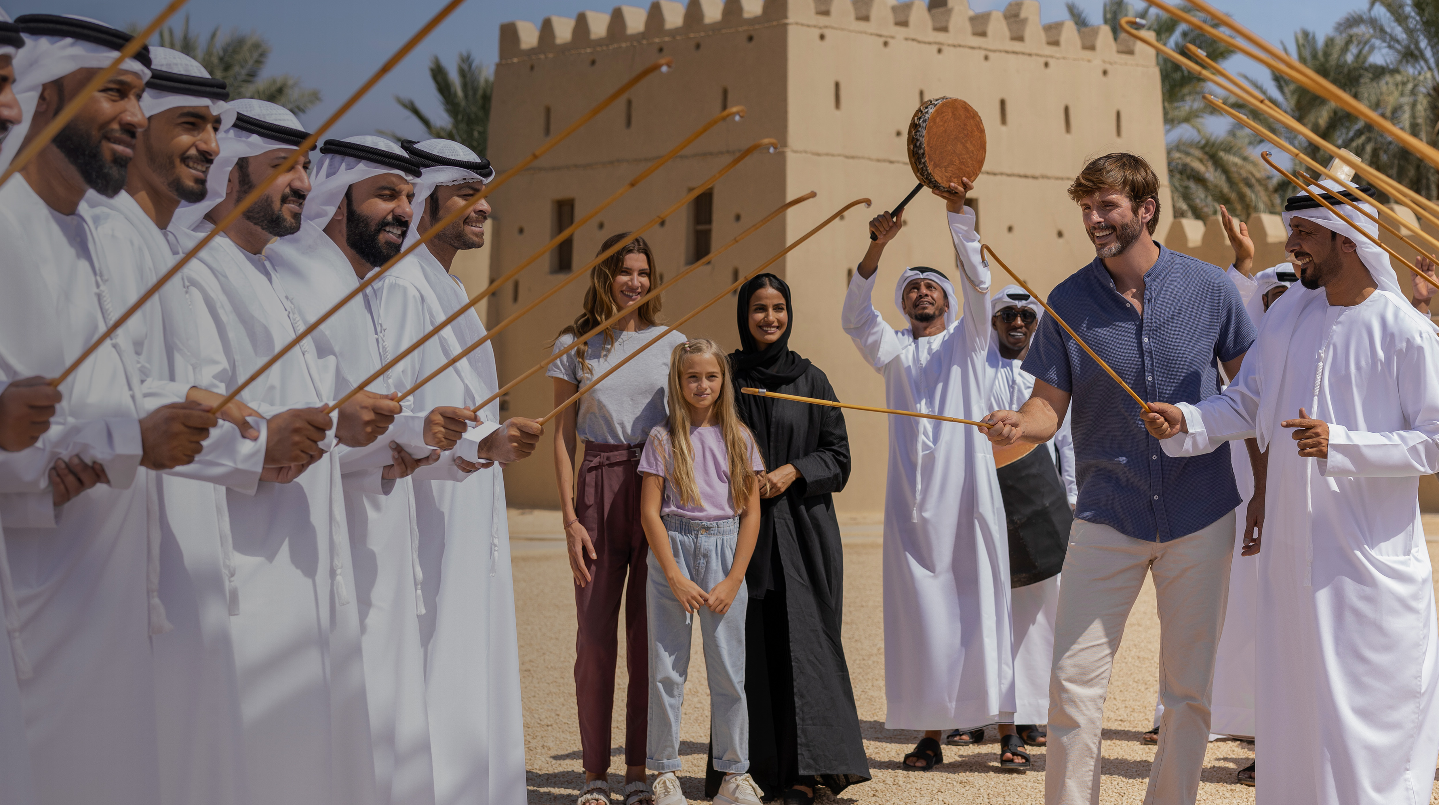 Visitors enjoying a traditional Emirati dance performance in Al Ain, Abu Dhabi.