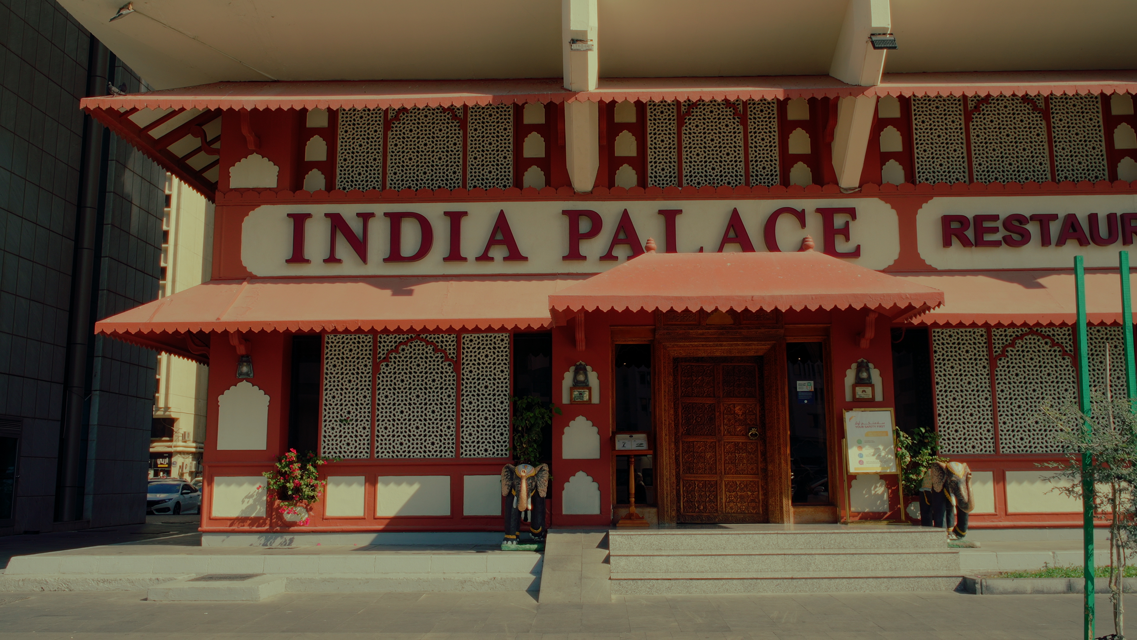 Red and white exterior of India Palace Restaurant in Abu Dhabi