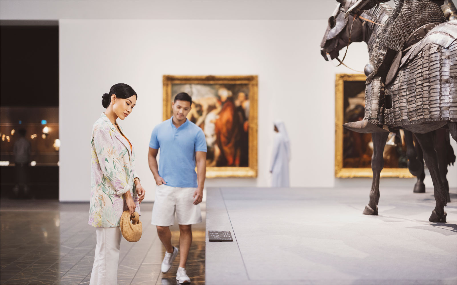 Couple exploring historic artifacts and exhibits on Saadiyat Island in Abu Dhabi.
